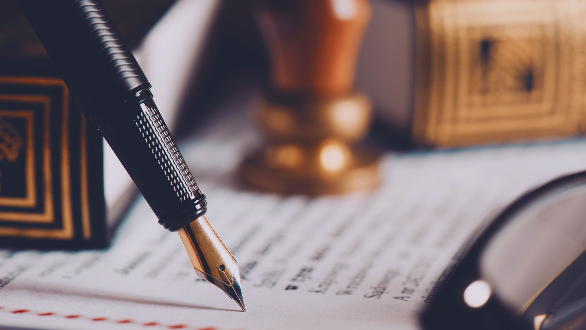 Image of a pen and paper with glasses next to the paper